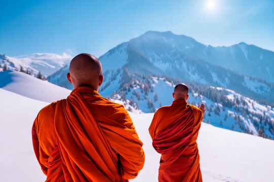 buddist monks praying in the snow mountains , from behind