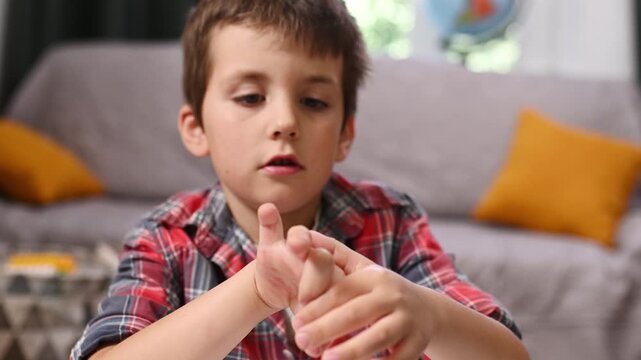 A child counts on his fingers in front of a laptop screen, remote classes. Online school. Homeschooling math. Early development of math skills. Mental arithmetic.