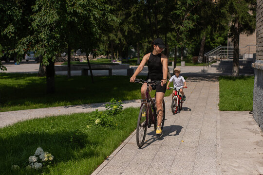 Mother and son riding a bicycle. 