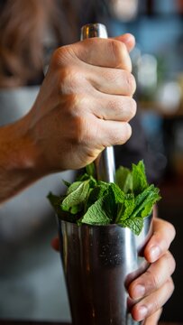 Bartender Muddling Mint for Cocktails