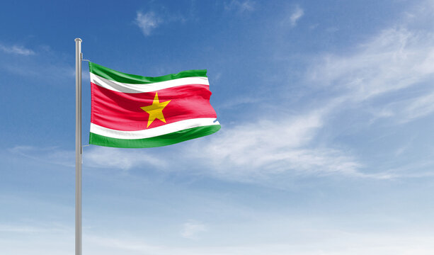 Suriname national flag waving in the sky.