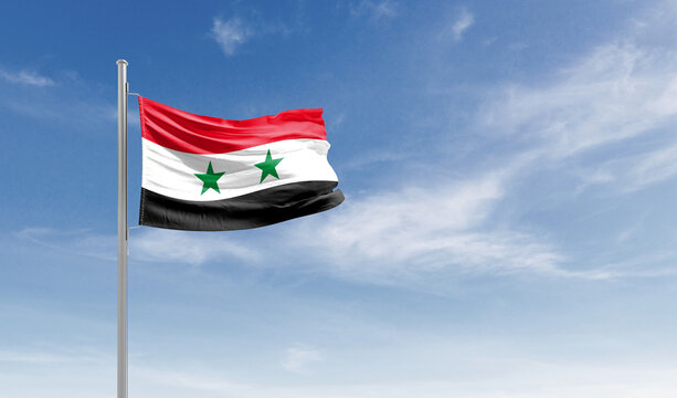 Syria national flag waving in the sky.
