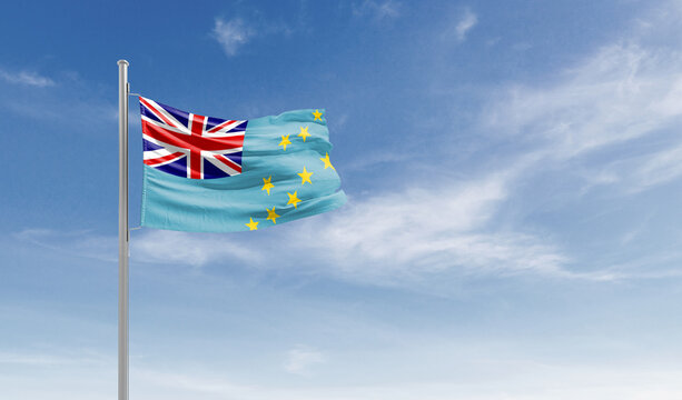 Tuvalu national flag waving in the sky.