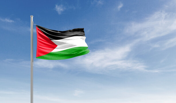 Palestine national flag waving in the sky.