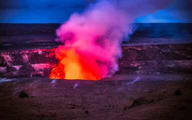 Active Kilauea volcano crater erupting with molten lava and volcanic gases against a dark stormy sky. Hawaii Volcanoes National Park, Big Island, Hawaii, United States. © KimVermaat