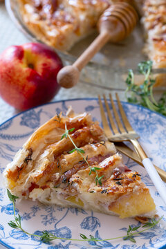 Piece of pie with nectarines and camembert.