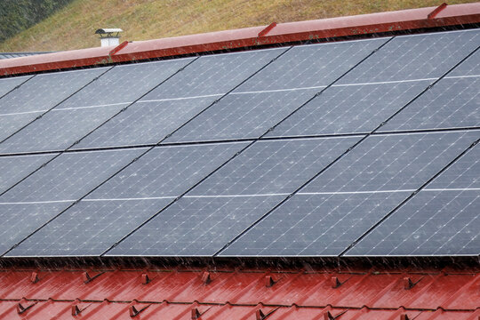 Rooftop solar panels during a torrential downpour.