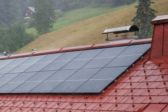 Rooftop solar panels during a torrential downpour.