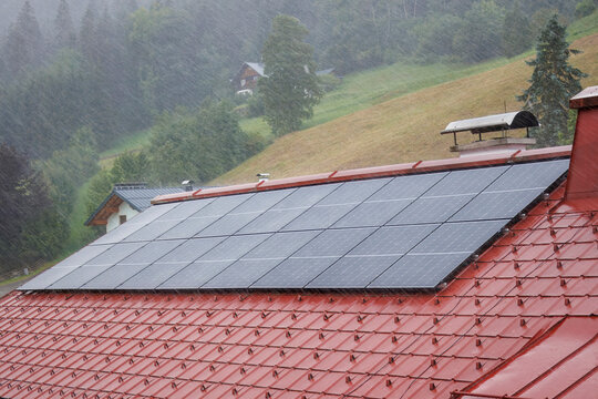 Rooftop solar panels during a torrential downpour.