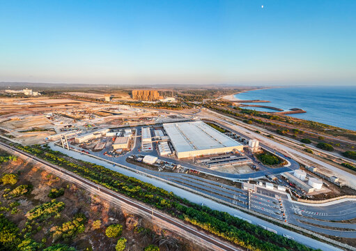 Aerial view of hyperscale data center industrial port facilities and surrounding infrastructure along the coastline in Sines, Setubal, Portugal.