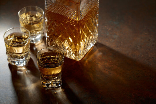 Decanter and small glasses of whiskey.