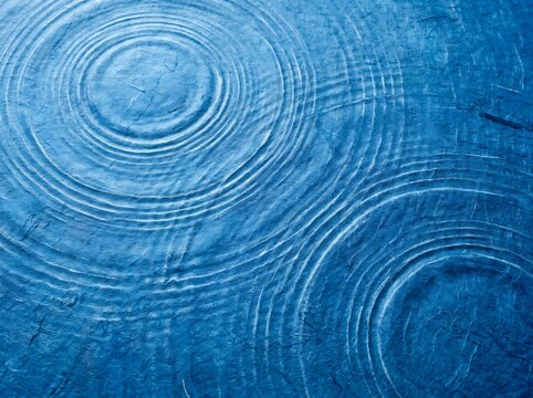 Concentric water ripples on a calm surface.