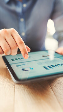 Analyzing business reports displayed on a digital tablet screen