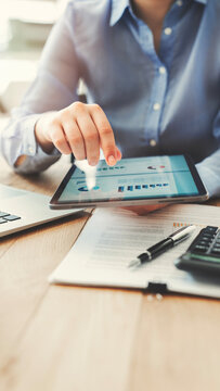 Analyzing business reports displayed on a digital tablet screen