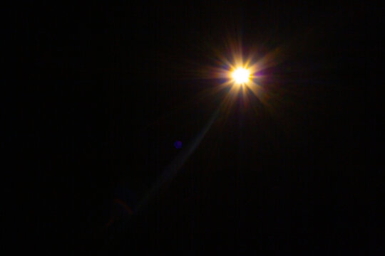Sun flare on the black background