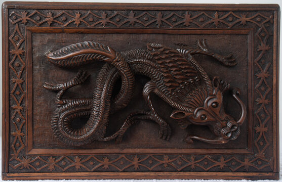 An antique Kashmiri box with a dragon carving on the lid