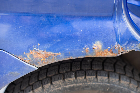 Close-up of a rusty car wheel arch. 