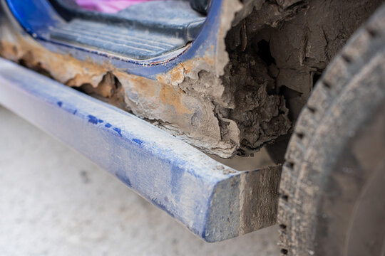Close-up of a rusty car sill and arch. 