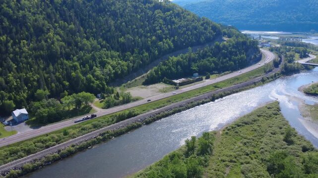 Aerial view of Route 132 winding along the famous Matapedia salmon river near a road bridge in the beautiful Matapedia Valley.