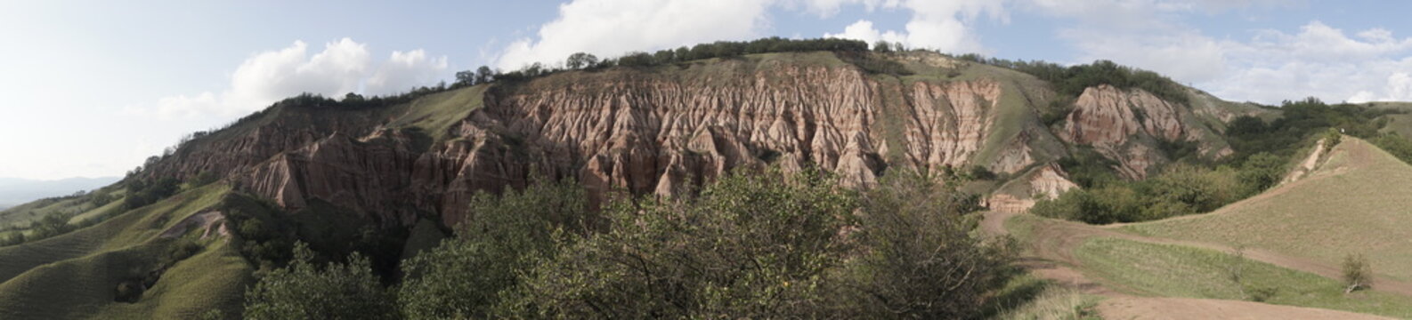 Panoramic view of R&acirc;pa Roșie red ravine and clay formations in Romania