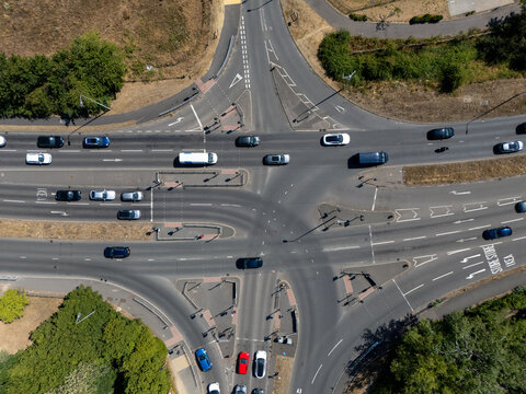 Aerial view of the Bath Road intersection with vehicles navigating the junction surrounded by green vegetation in Calcot, England, United Kingdom.
