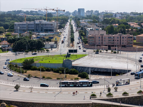 Aerial view of the roundabout at Avenida da Boavista with an equestrian statue, urban buildings, traffic, and construction cranes in Matosinhos, Porto District, Portugal.