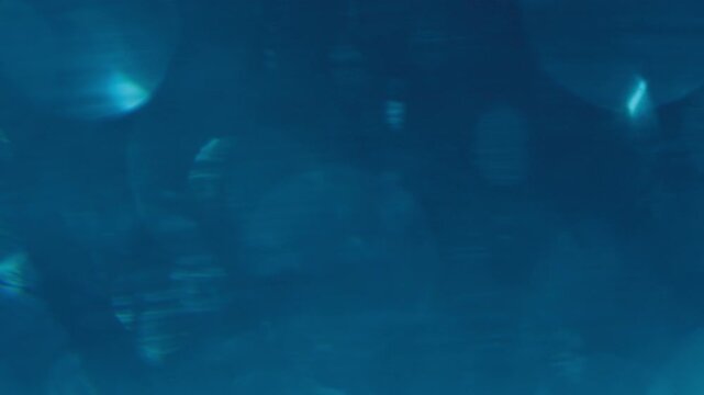 Video footage of shimmering "Millennium Silver" particles set against a blue atmosphere, evoking a sense of intrigue, luxury, sophistication, and a futuristic world.