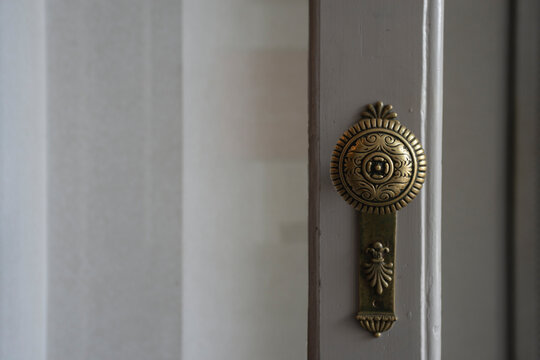 Old vintage door handle on white door