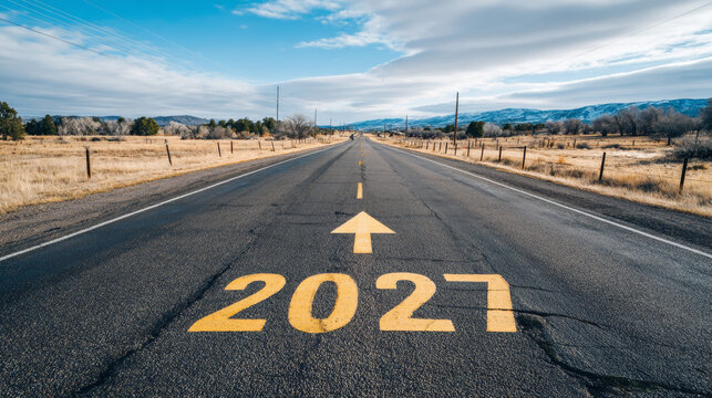 Road to 2027 with an empty road with written 2027 and arrow pointing towards the horizon to represent the future and positivity and success of the new year 2027
