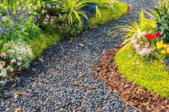 colorful flowers with rock path leading through a flower garden