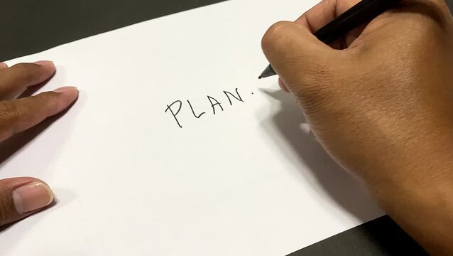 Hand writing Plan B on white paper with black marker pen for business alternative concept. backup planning.