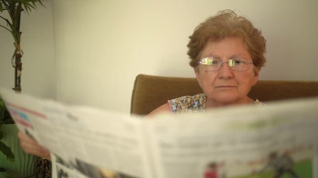 senior woman reading newspaper