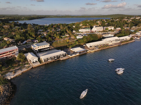 Aerial view of the coastal town of Vava'u with its harbor, small boats, and buildings along the waterfront in Vava'u, Tonga.