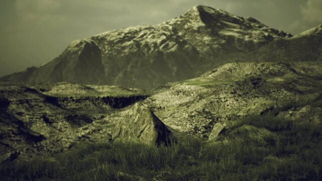 Textured grassy mounds beneath bleak mountain, muted green palette and scattered shadows with low cloudbank, cinematic filmic toning highlights rugged contours