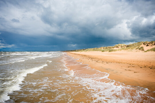Dark cloudy sky over long sandy beach near Mellbystrand in Laholm Municipality, Sweden