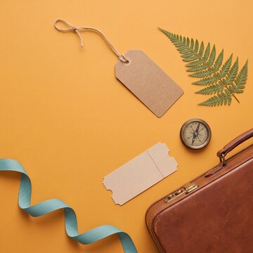 Travel flat lay from above with vintage suitcase and compass
