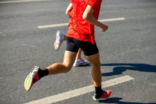 Two male runners running marathon in road city.