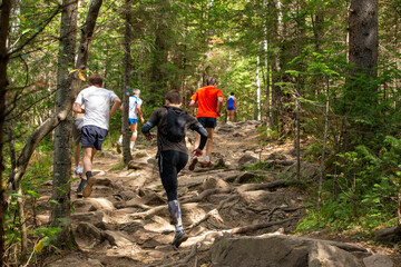 Obraz premium Group runners is running marathon race in uphill over stones
