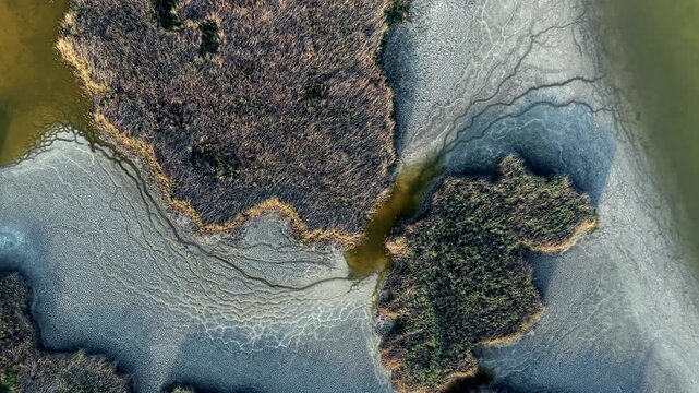 Aerial drone view of Lake Velence, Hungary, revealing severe drought, shrinking shoreline and dried wetlands during the summer.