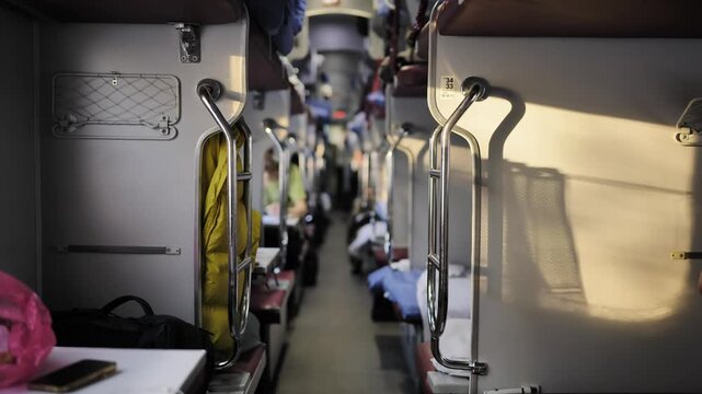 Train sleeper car interior with beds and aisle during a long journey