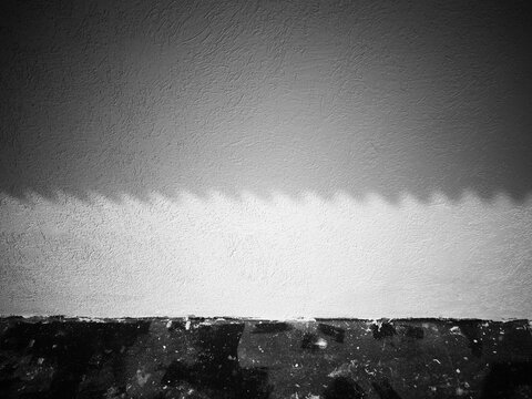Dramatic shadow from the roof slate on the street wall backdrop