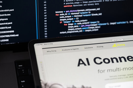 Kong Ai company web page on program code background