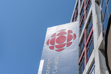 Fototapeta premium Toronto, ON, Canada - August 5, 2026: The logo and signage of the Canadian Broadcasting Corporation (CBC) is seen at their Broadcasting Centre in Toronto, ON, Canada. 