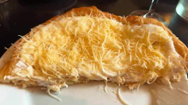 Traditional Hungarian langos folded with melted cheese and generously topped with grated cheese. Popular Hungarian street food served fresh in a restaurant. High quality 4k footage