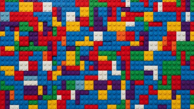 A vivid composition of colorful plastic building blocks forming a cheerful, intricate abstract pattern, perfect as a playful background for creative and imaginative design work