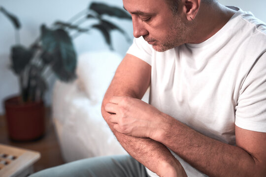 Man with elbow pain at home.