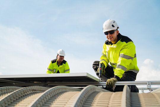 Solar electricity power technology for sustainable energy, construction worker, safety helmet, high visibility clothing, rooftop, solar panel installation, careful expression during outdoor