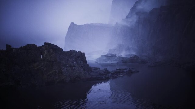 Narrow inlet with shadowed water and rocky terrain. Secluded bay enclosed by jagged limestone formations with shadowed pathways leading toward open ocean