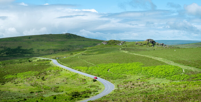 red car on road in dartmoor national park