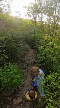 Woman and child walking through thorny bushes